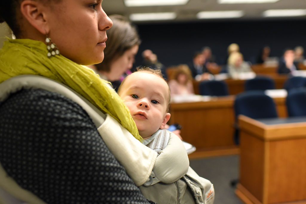 Jessica Mathenia and her daughter Kyrie Mathenia, 7 months, sit in on a debate about abortion